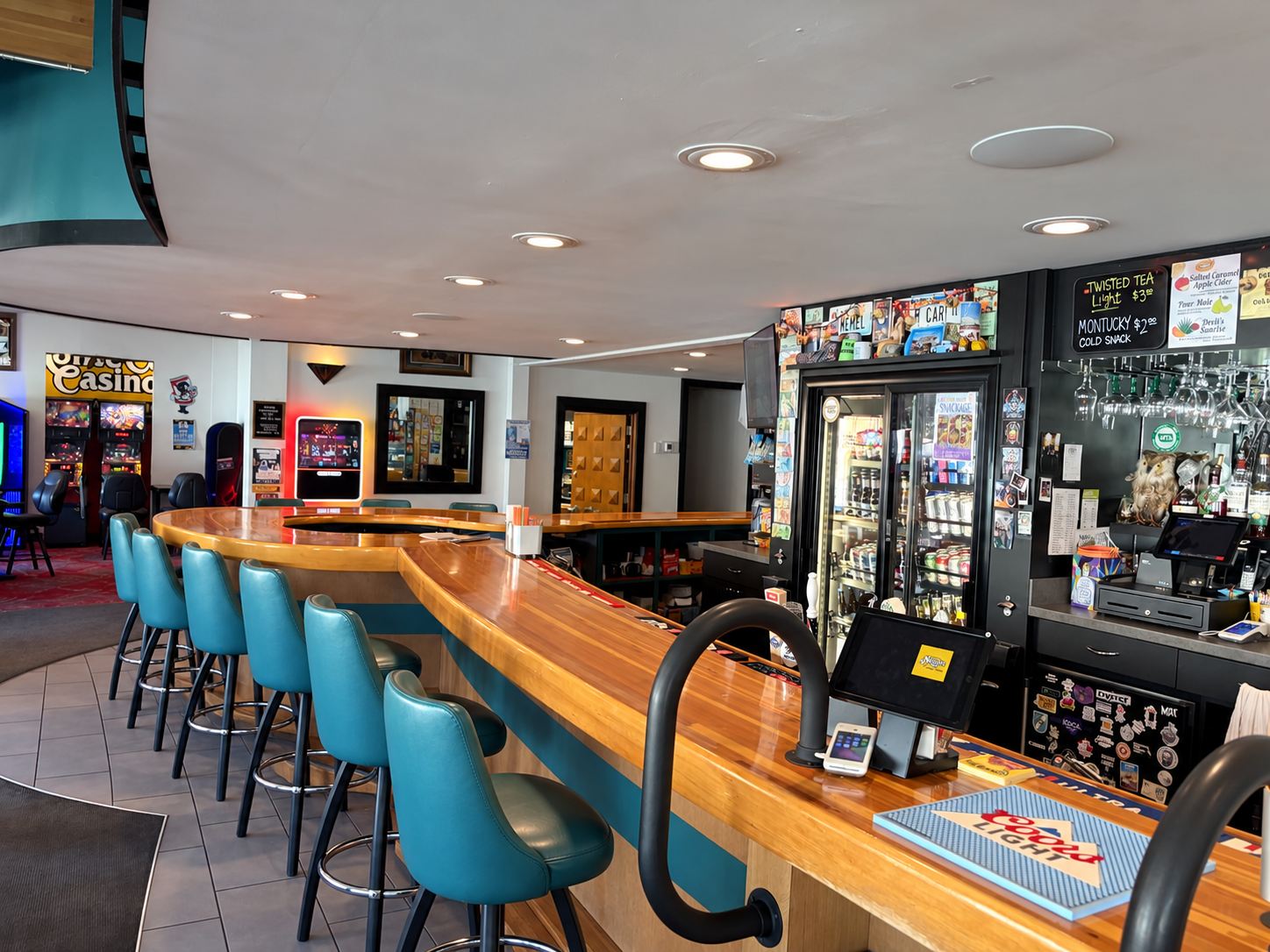 The Monte’s family-built curved wooden bar lined with teal chairs