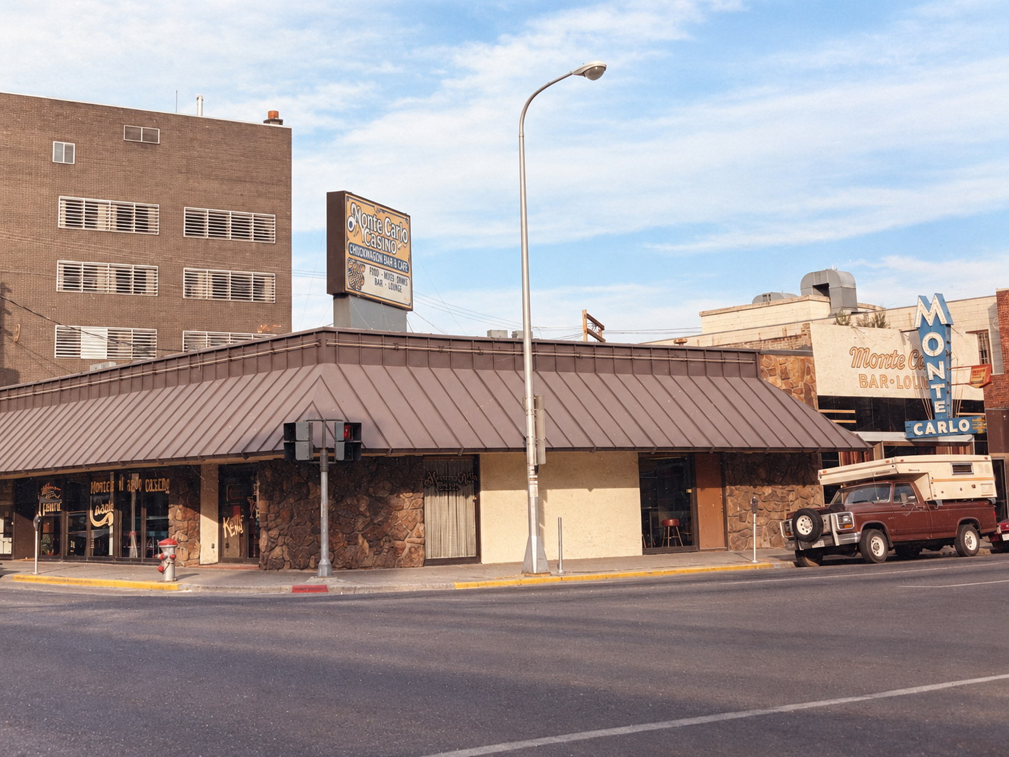 Vintage color photo of the Monte Carlo Casino and Monte Carlo Bar-Lounge neon sign on a downtown Billings corner